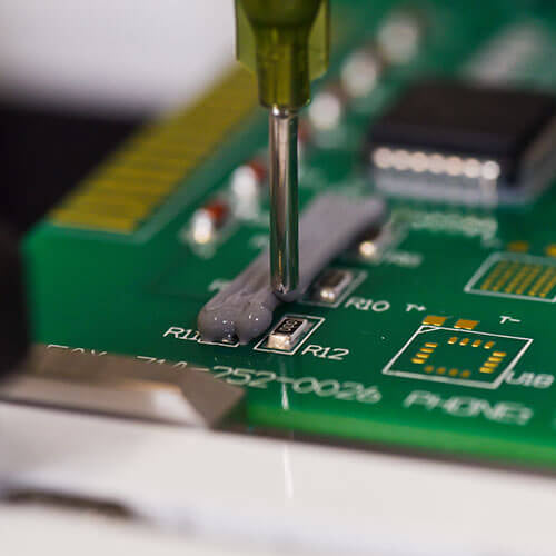 Encapsulation process using a handheld valve to apply protective material onto circuit board