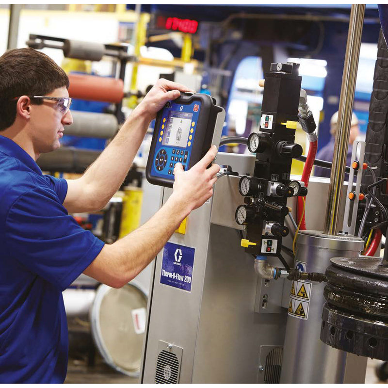 Application shot of worker programming the Graco Therm-O-Flow 200 Bulk Hot Melt System